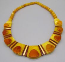 Early C20th yellow, brown and orange plastic necklace with screw closure
