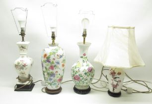 Four white ceramic table lamps florally decorated with some songbirds, with shades