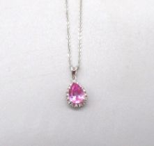 9ct white gold pendant set with teardrop cut pink stone surrounded by a halo of diamonds, on gold