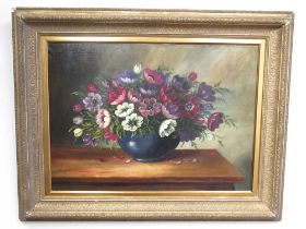 Agnethe Krag (Danish C20th); Still Life study of flowers in a blue vase on a table, oil on canvas,