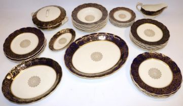 Quantity of Grindley Cream Petal dinnerware decorated in blue and gold, incl. soup bowls, tureen,