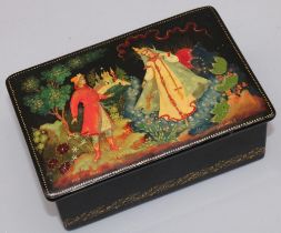 C20th Russian lacquered box decorated with a landscape scene with two figures, hinged cover, signed,