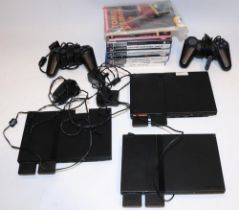 Three slimline PlayStation PS2 games consoles, controllers, and seven PS2 games (qty.)