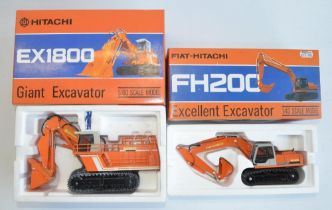 Two diecast Hitachi plant models from Shinsei, both with working metal tracks to include 1/60