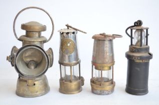 Four vintage metal lamps to include Wolf Safety Lamp, a Type 6 Eccles safety lamp by The Protector