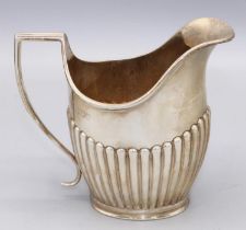 Late Victorian Silver milk jug, part lobed with a angled sweeping handle, London, 1896, Charles