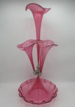 Victorian style cranberry glass epergne with four flutes on a scalloped edged circular base, H53cm