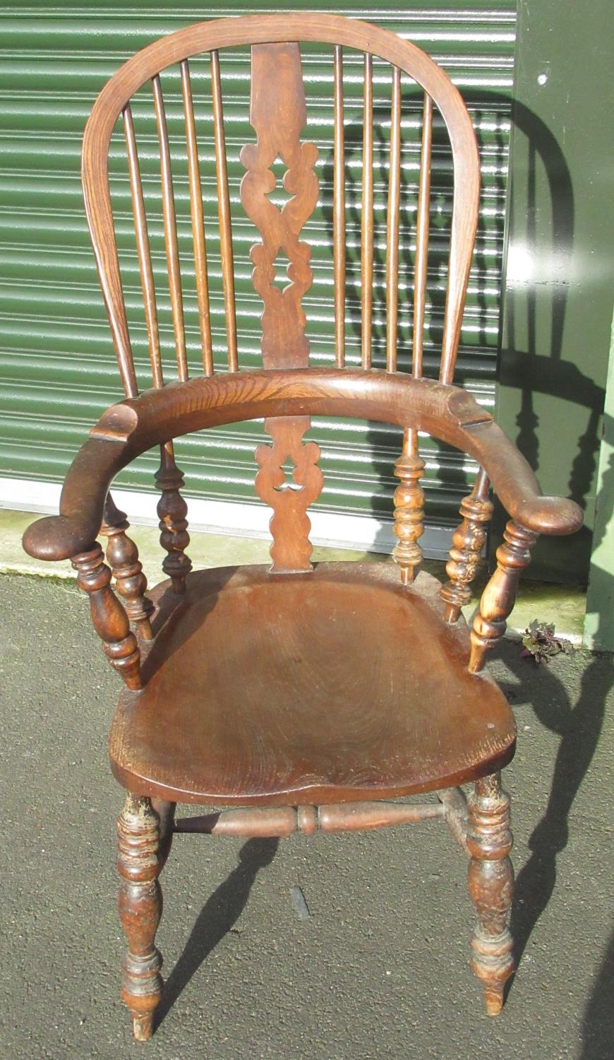C19th ash and elm broad arm, high back Windsor chair on turned supports joined by stretchers