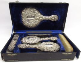 Cased Edwardian silver vanity travel set with mirror, four brushes & comb, cased in a blue velvet