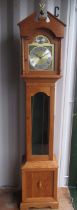 C20th light oak long cased clock, arched dial above glazed door on panel base with bracket feet,