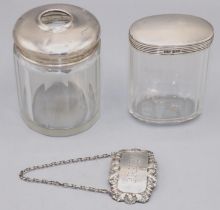 Two Art Deco dressing table silver and glass jars, of a oval and round shape, London, 1927,