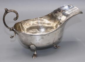 Art Deco Silver sauce boat with scalloped edges and a sweeping curved handle, Sheffield, 1927,