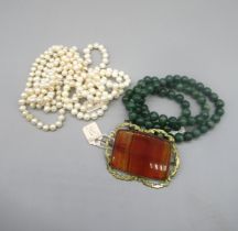 Ornate yellow metal rectangular brooch set with large agate, a string of jade beads with white metal