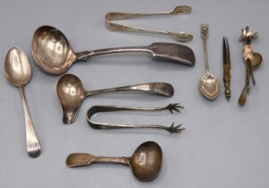 Collection of silver ladles, sugar tongs, spoons, five cocktail skewers & a metal compass, all