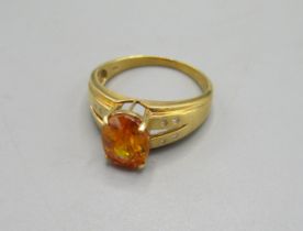 18k yellow gold ring set with oval cut orange stone on diamond shoulders, stamped 18k, size Q, 5.2g