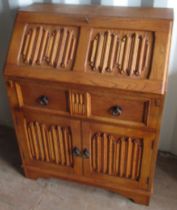 Light oak bureau, with linen fold detail, fall front with fitted interior above drawer and two doors