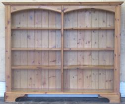 Modern pine open bookcase, with arched frieze and six shelves on bracket feet, W147cm, D32cm, H123cm