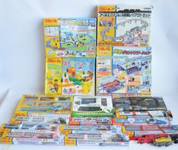 Collection of Tomy and Takara Tomy battery powered plastic model train sets to include trains packs,