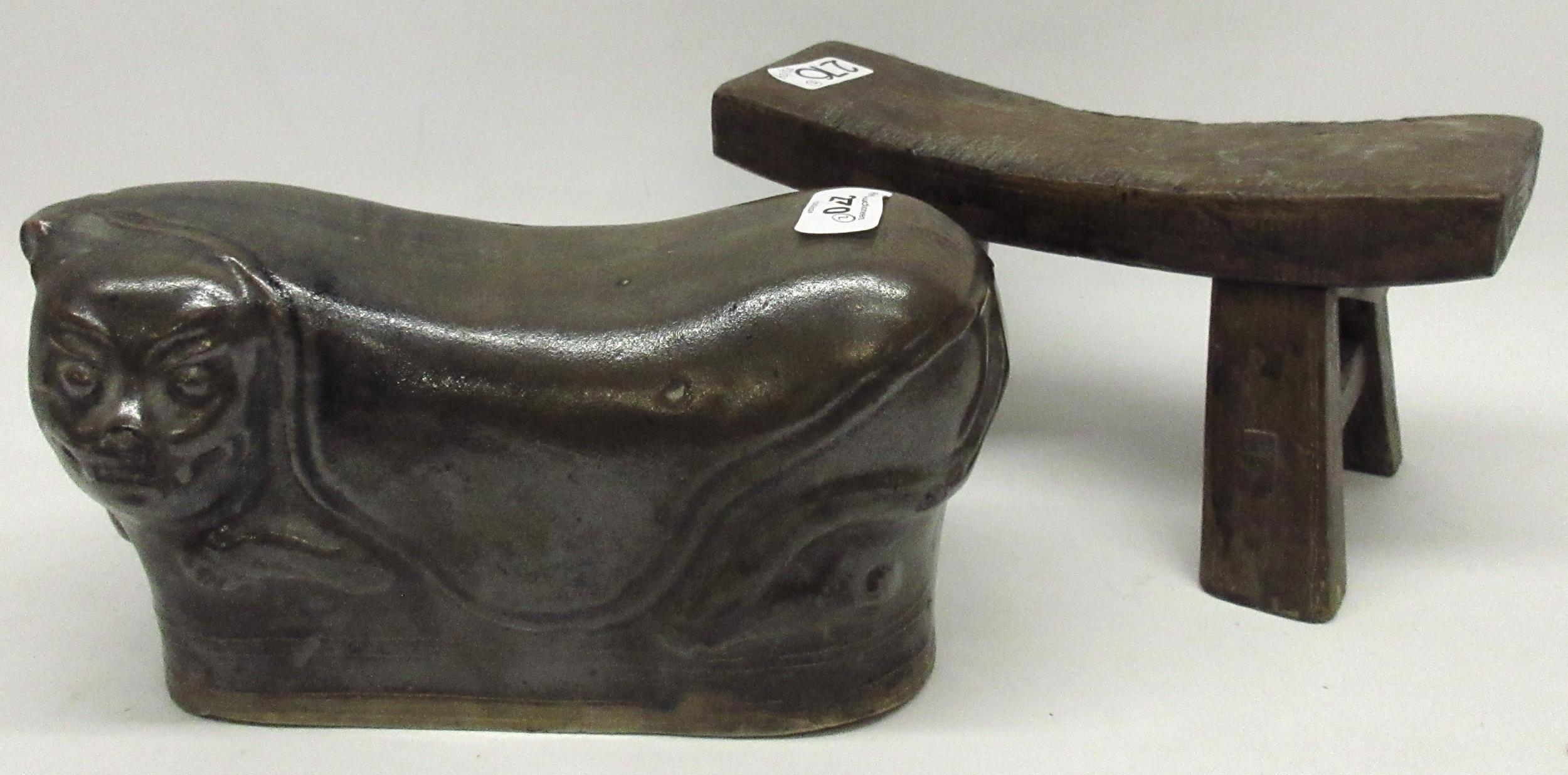 Chinese stoneware head rest modelled as a reclining cat, and a similar wooden head rest, max.