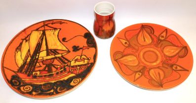 Poole Pottery Delphis - two chargers, one decorated with a ship, and a vase, decorated in orange,