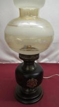 Oil lamp converted to electric with wooden base and brass crests (missing chimney)