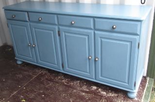 Blue finish dresser, with four drawers above four panel doors with faceted metal ball handles, on