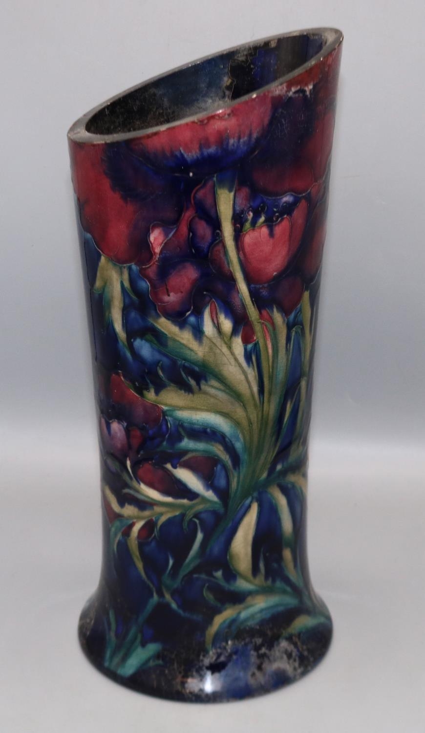 Moorcroft Pottery: cut down vase, with red flowers on dark blue ground, H34cm, A/F