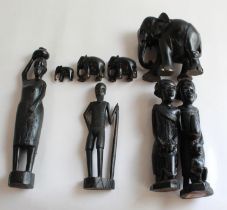 Tribal carvings including mother and father with children, village elder, water carrier and four