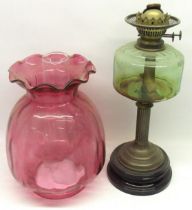 Late Victorian paraffin oil lamp with green tinted reservoir, fluted column on circular moulded