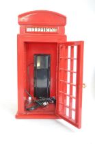 Novelty red telephone box phone by Astral International, 2 clowns and 2 Great War medals to