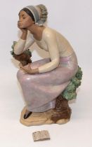 Lladro figure - 'Poetic Moment, #12299, modelled as a woman seated on a tree stump with book, H32cm,