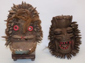 Two wooden African tribal masks, and a display stand, max. H35cm