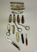 Collection of miniature knifes with various handles, including silver fruit knife, “bottle” knifes