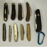 Collection of vintage pocketknives including modern “the forester” Swiss Army knife.