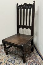 C18th oak back stool with scroll carved cresting and solid seat on turned supports
