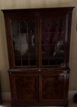 C19th mahogany side cabinet, with lobed cornice above a pair of gothic moulded glazed doors, the