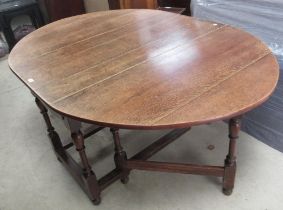 C17th style oak oval gateleg dining table, with two end drawers on turned supports with