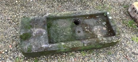 A stone carved butlers sink 104 x 44 approximately 14cm high