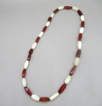 Polished red and white quartz beaded necklace, on knotted thread