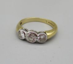 18ct yellow gold three stone diamond ring, the three round cut diamonds, stamped 750, size O, 4.0g