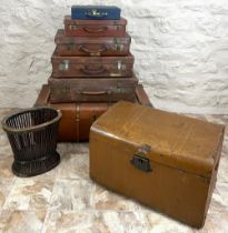 Collection of suitcases, scumbled tin trunk, an initialed wood bound trunk, and a waste paper