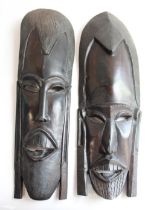 Pair of hand carved barley twist hardwood walking canes, one A/F, and two Kenyan carved wood