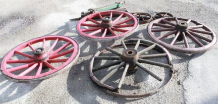 Assorted collection of coopered wheels, pair of cast wheels, axle and swivels, metal strapping, etc.