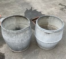 Two galvanised dolly tubs, one with a star on the base and dated 1933