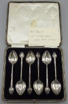 Cased set of six Art Nouveau silver coffee spoons with monogrammed spade finials and a hanoverian