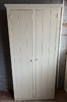 White painted pine cupboard, moulded cornice and planked doors, W85cm D34cm H173cm
