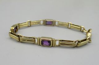 9ct yellow gold fancy link bracelet set with three emerald cut amethysts, with dog clip clasp,