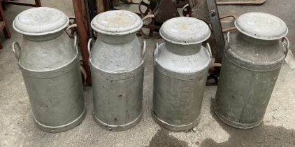 Four galvanised milk churns with lids and handles one by “United Co-op dairies ltd” and three by “