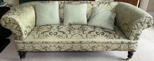 Victorian style Chesterfield sofa, with outsplayed arms on turned supports with brass sockets and