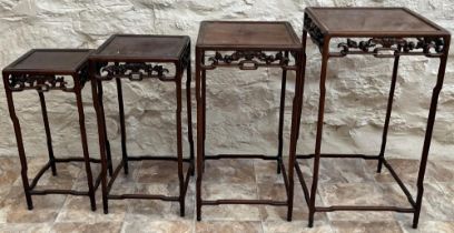 Nest of four late 19th century Chinese hardwood quartetto tables, with moulded square top and floral